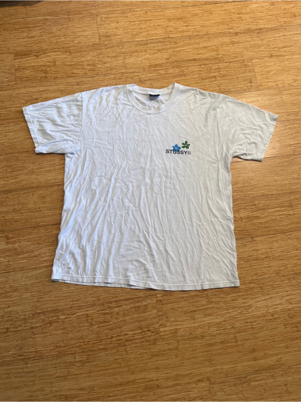 White Stussy flower green blue pocket logo graphic t-shirt